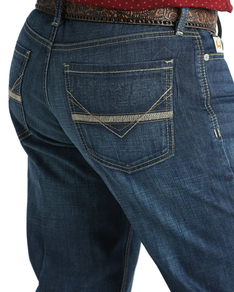 Close-up of blue jeans with a focus on the back pocket on a white background