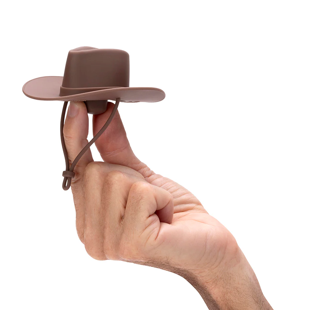 Monkey Business Howdy Bottle Stopper Set 2. Hand holding a small brown cowboy hat against a white background