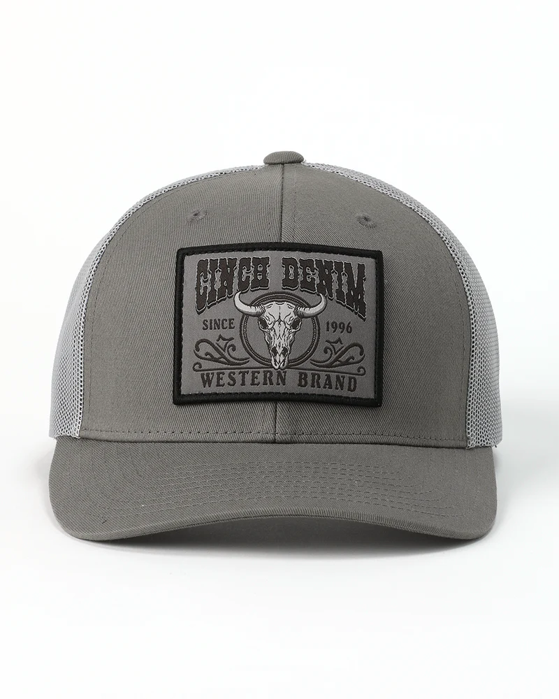 Cinch Men's Mid-Profile Trucker Cap. Gray trucker hat with a black patch featuring a bull skull design on a white background