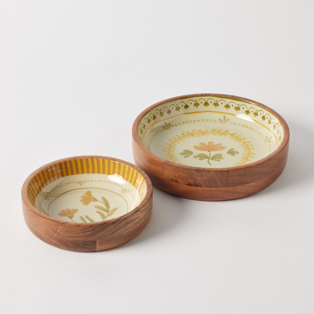 Two wooden bowls with floral patterns on a white background