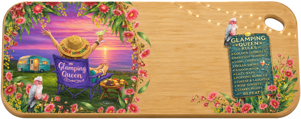 A rectangular wooden cutting board with rounded corners and a handle cutout, printed with a whimsical camping scene titled 'Glamping Queen.' The left side shows a person lounging in a purple folding chair by a campsite with a trailer, flowers, and a sunset sky.