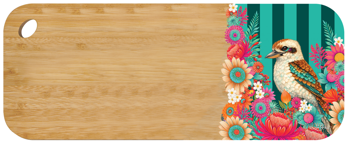A rectangular cutting board with rounded corners, a natural light wood grain finish on most of the surface, and a decorative floral-and-bird print along the right edge. The print features a kookaburra bird surrounded by bright pink, orange, teal, and white flowers on a striped teal background.