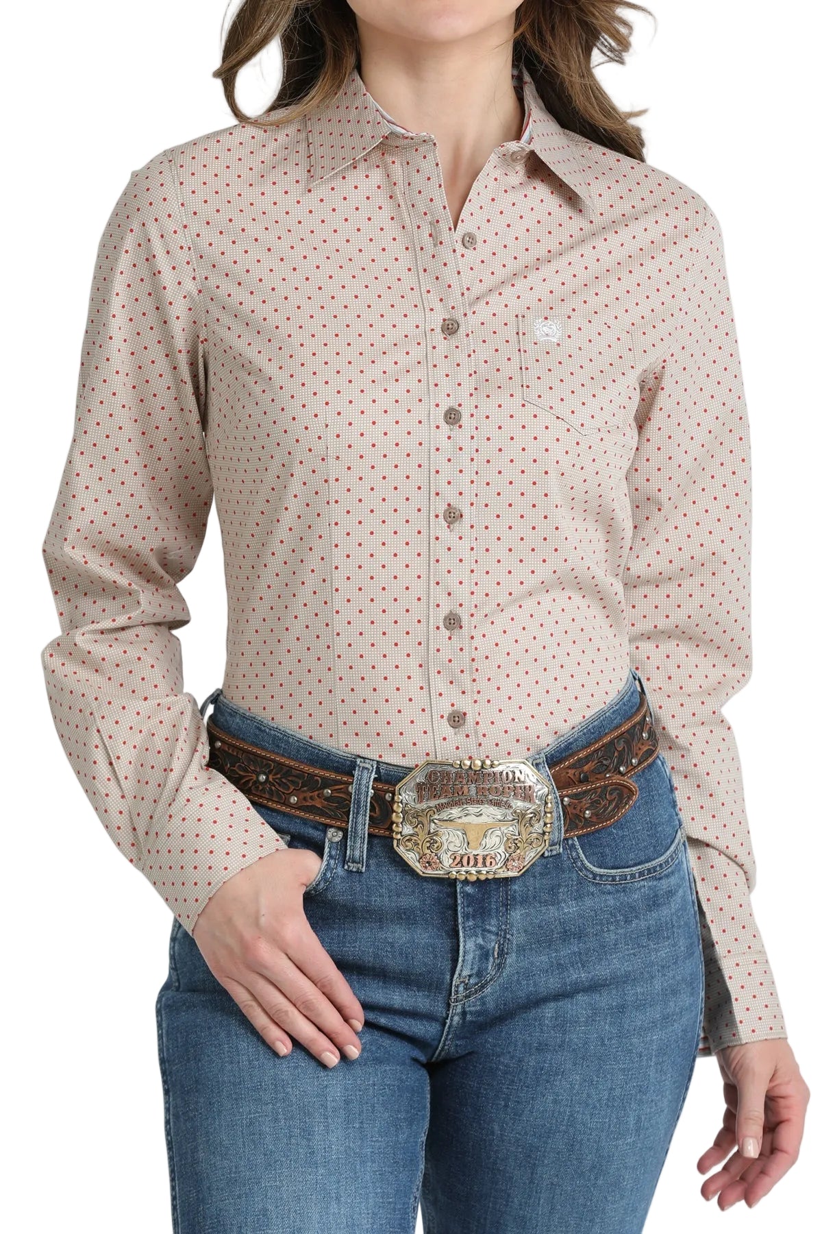 Woman wearing a patterned shirt and jeans with a belt on a white background