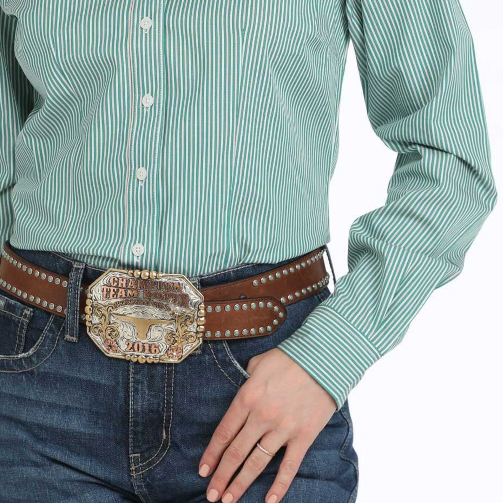 Person wearing a green striped shirt and blue jeans with a decorative belt.