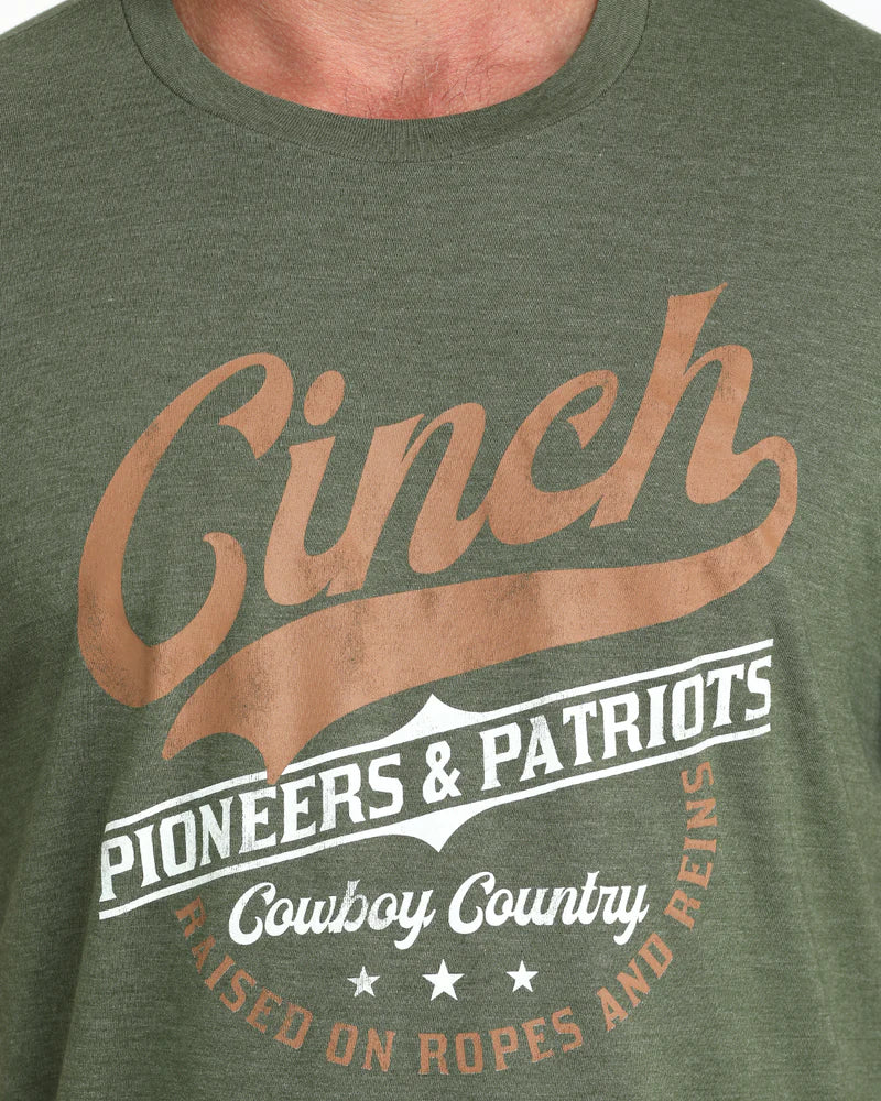 Cinch Men's Graphic Tee. Green t-shirt with 'Cinch' branding and text on a green background