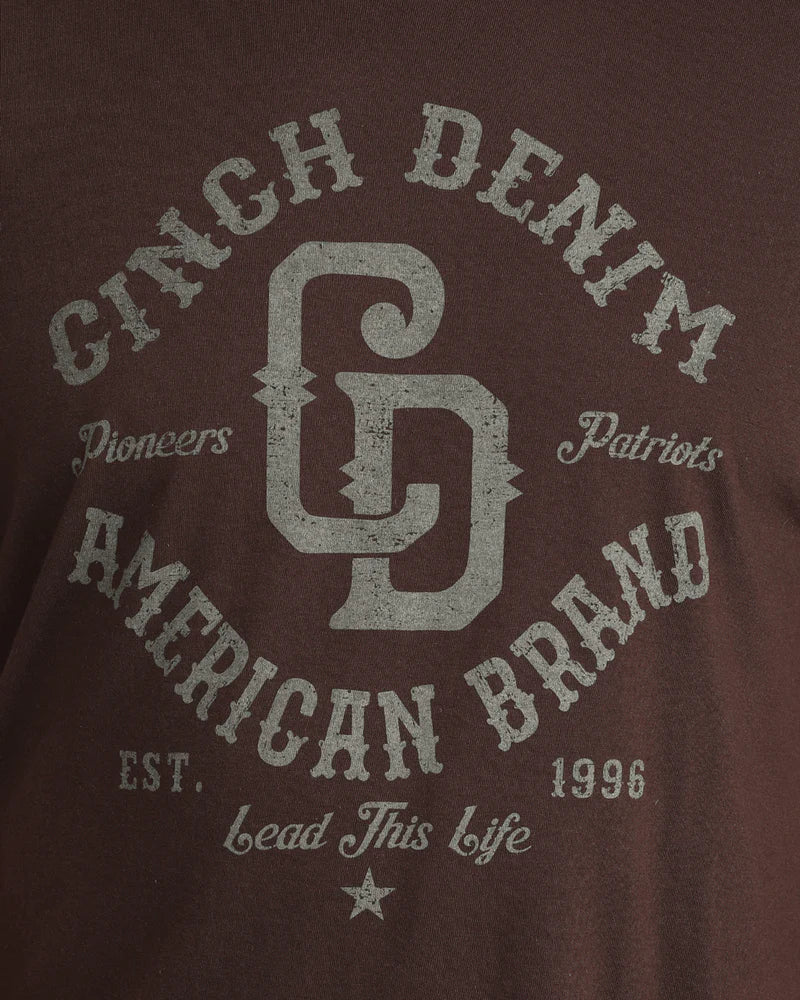 Brown t-shirt with 'Ginch Denim American Brand' text and logo on a brown background