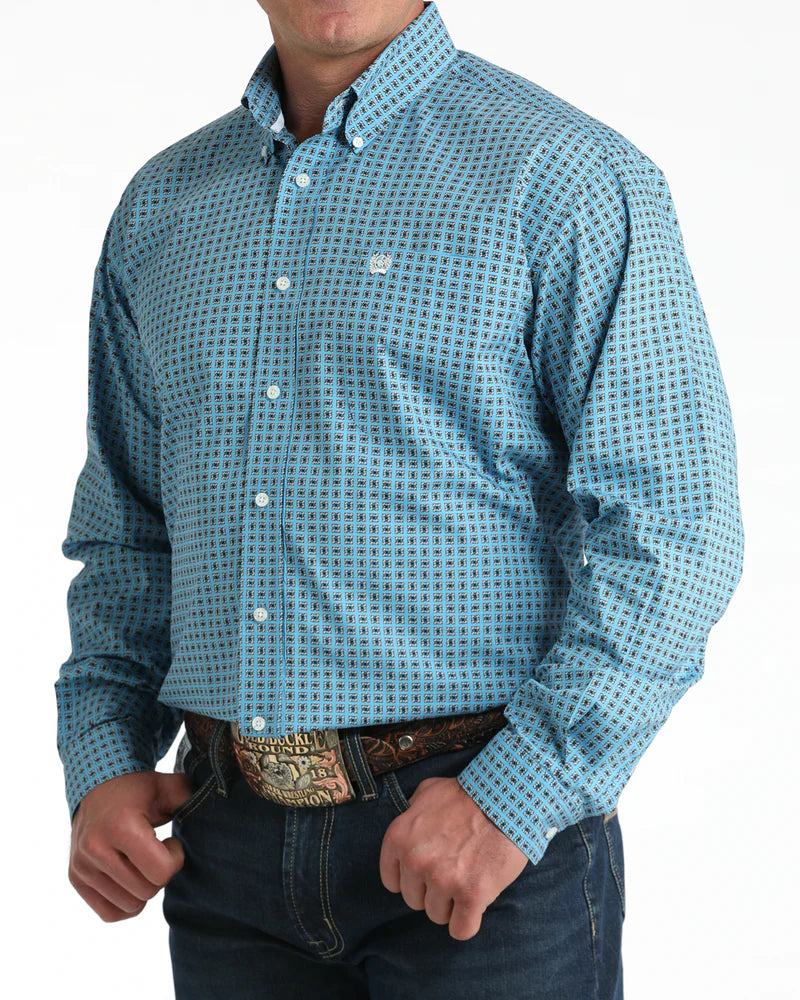 Man wearing a blue patterned shirt with a white background