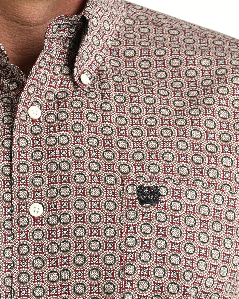 Close-up of a patterned shirt with a focus on the collar and buttons.