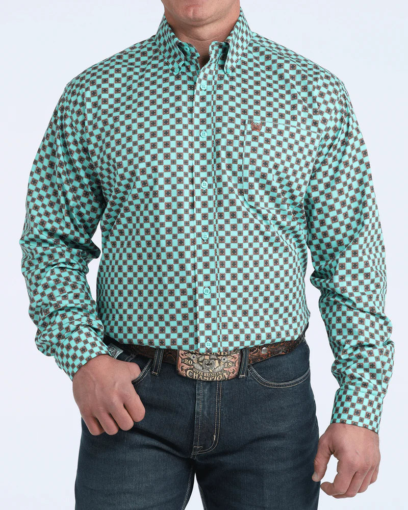 Man wearing a green and brown checkered shirt with rolled-up sleeves on a white background
