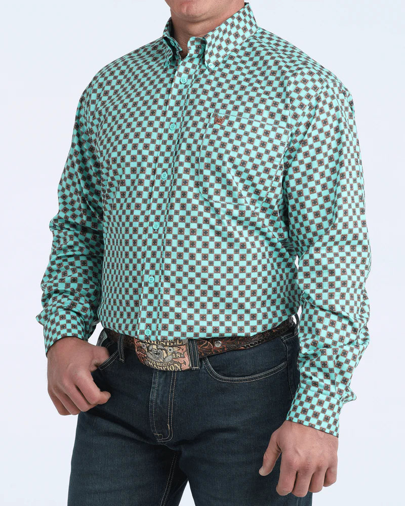 Man wearing a green and brown checkered shirt with rolled-up sleeves on a white background