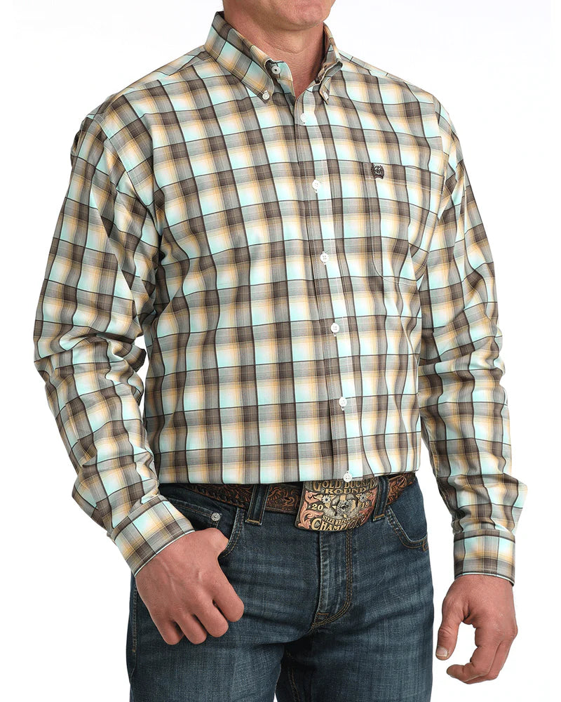Man wearing a plaid shirt and jeans with a belt on a white background