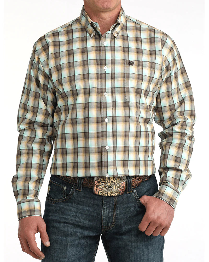 Man wearing a plaid shirt and jeans with a belt on a white background
