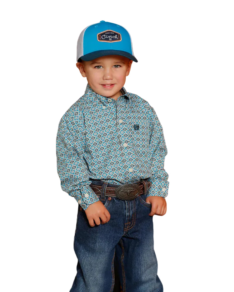 Cinch Boy's Toddler L/S Western Shirt. Child wearing a blue cap and patterned shirt.