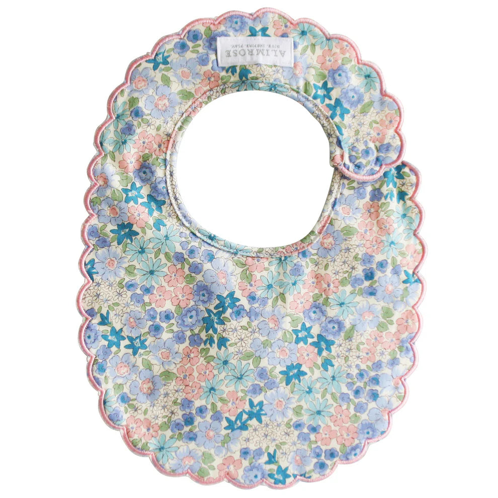 Alimrose Scallop Bib Liberty Blue. Floral patterned baby bib on a white background