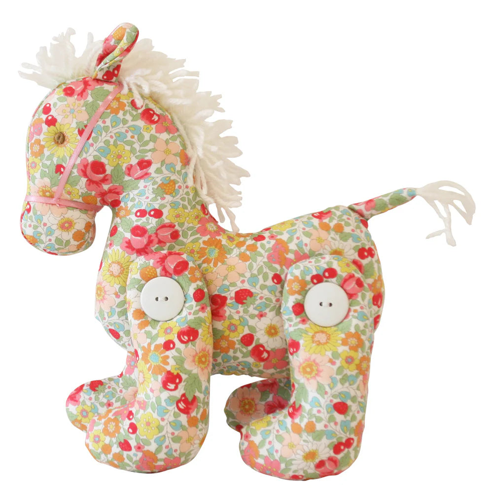 Floral-patterned plush horse toy on a white background