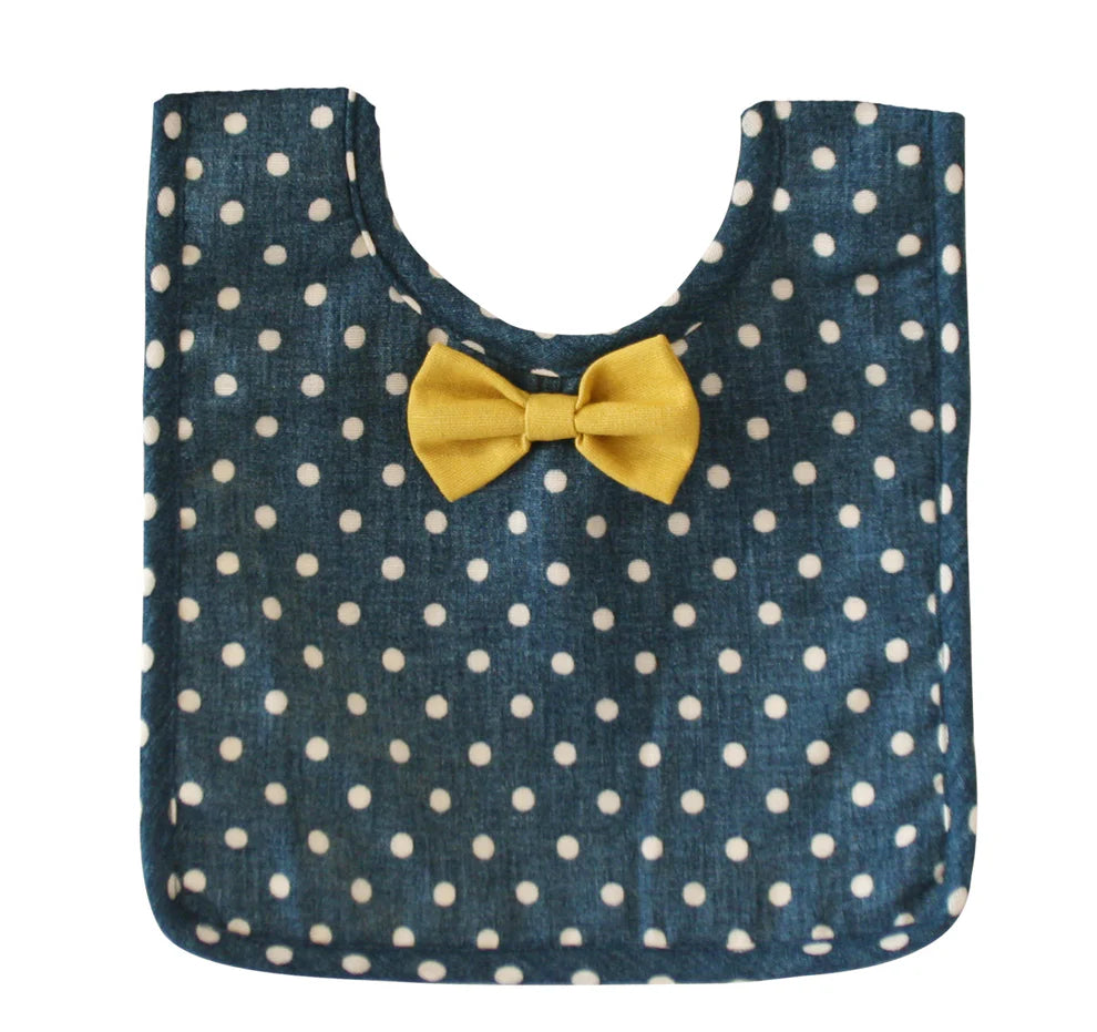 Blue polka dot bag with a yellow bow on a white background