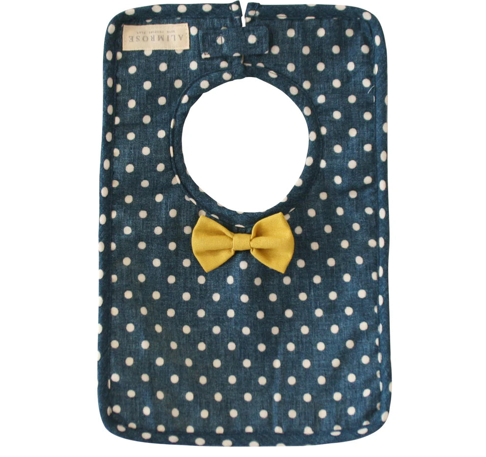 Blue polka dot bag with a yellow bow on a white background