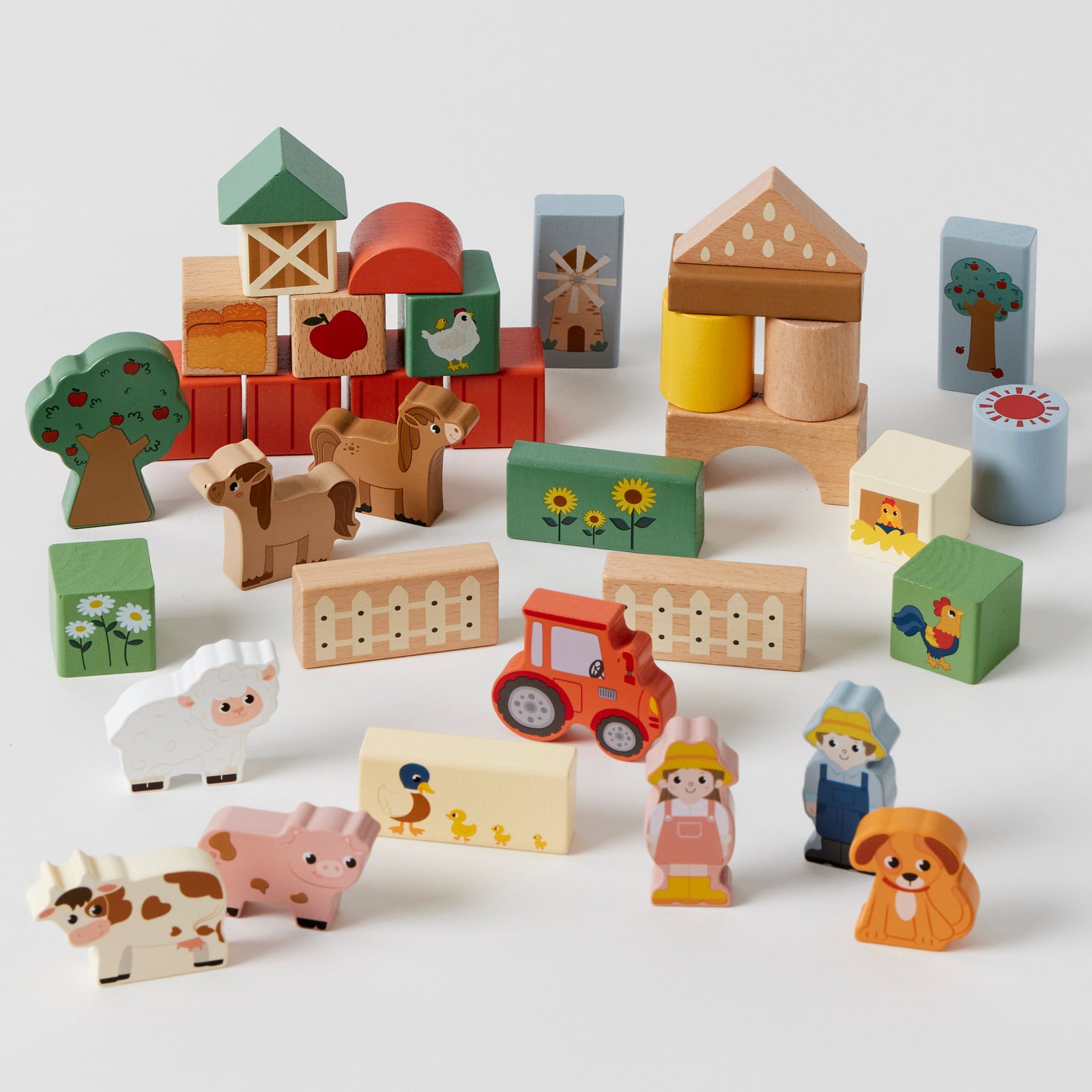 Set of wooden toys including animals, buildings, and vehicles on a white background