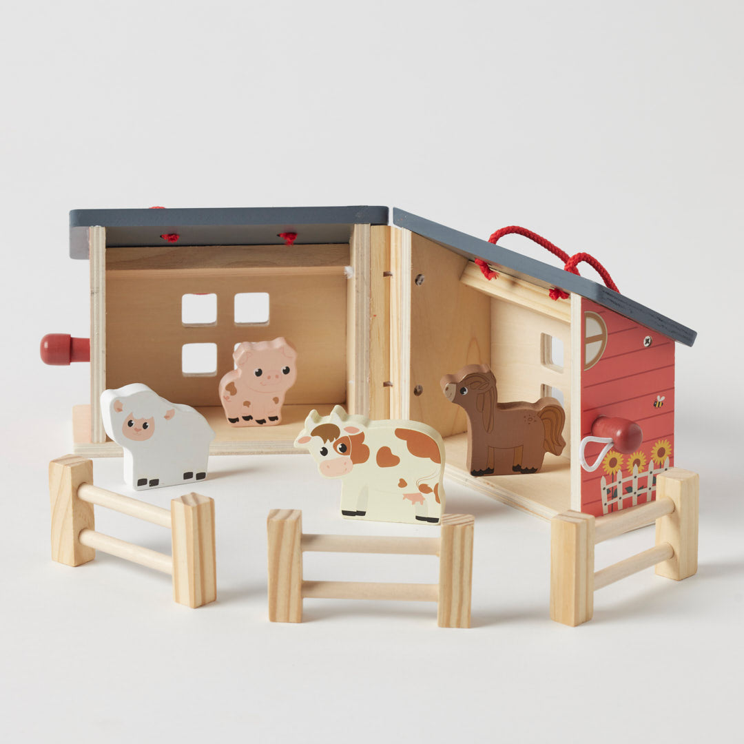 Wooden farm set with barn and animals on a light gray background