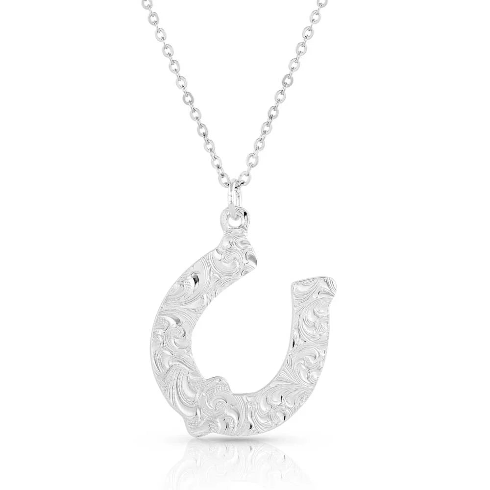 Montana Silversmiths Diamond Horseshoe Necklace. Silver necklace with a decorative pendant featuring a turquoise stone on a white background
