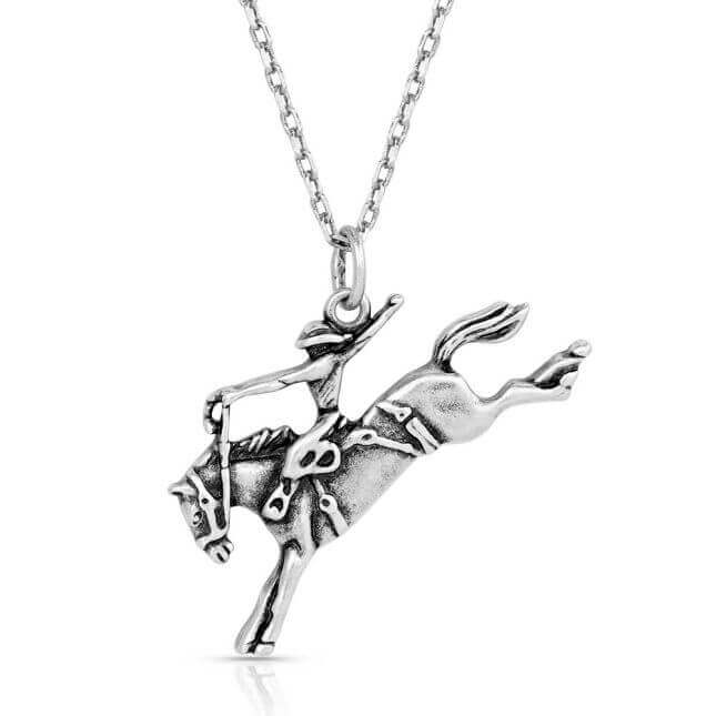 Montana Silversmiths Saddle Bronc Rider Pendant Necklace. A silver-tone pendant necklace featuring a saddle bronc rider figure, displayed against a white background.