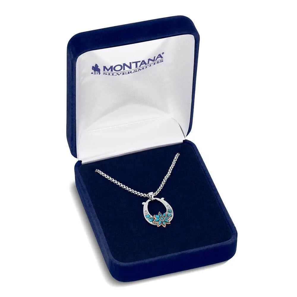 Jewelry set with necklace and earrings in a Montana Silversmiths box on a white background