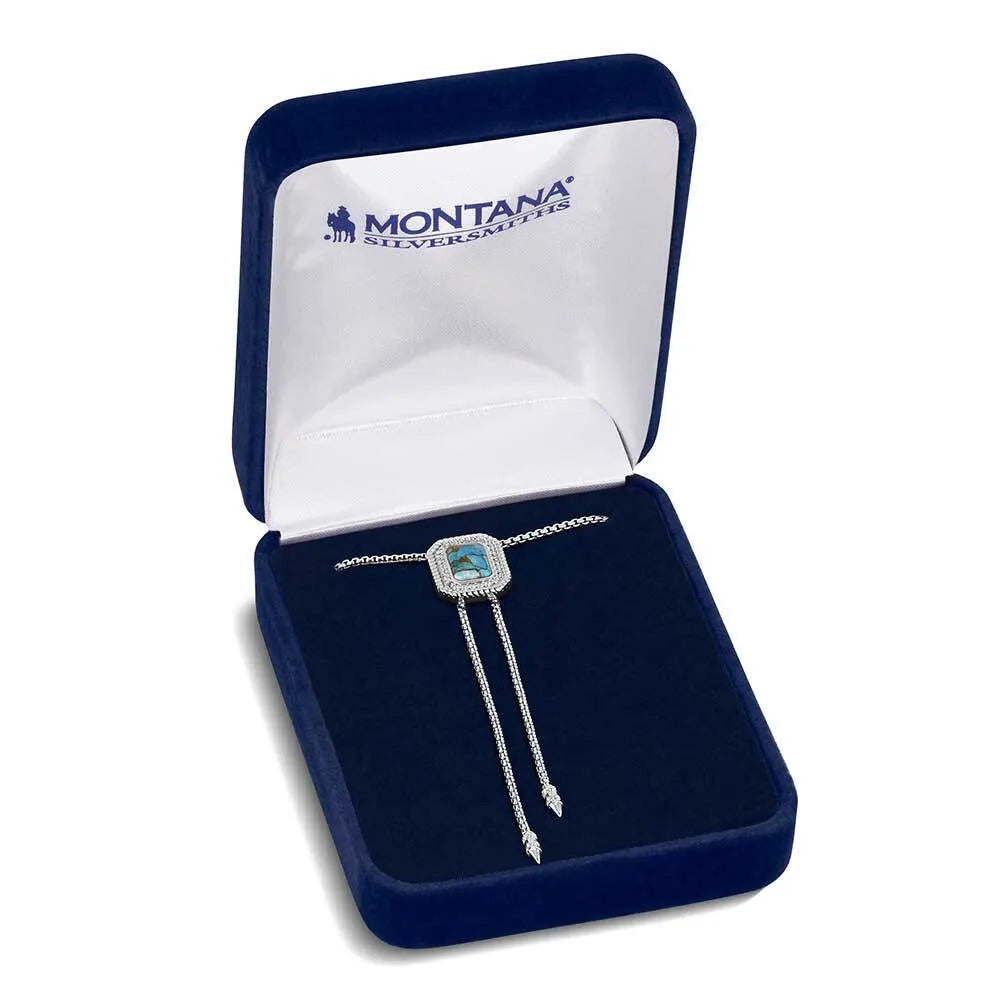 Silver necklace with a blue gemstone in a Montana Silversmiths box on a white background