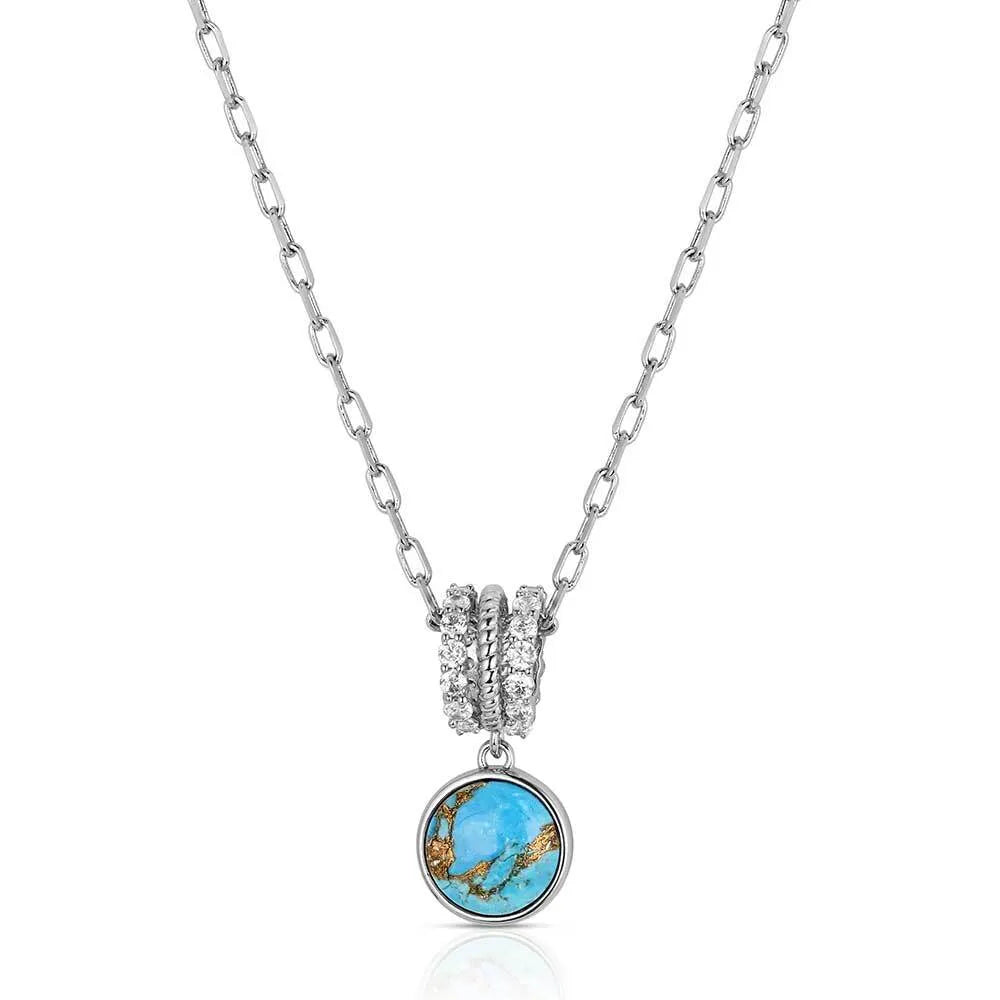 Necklace with a turquoise pendant and silver chain on a white background