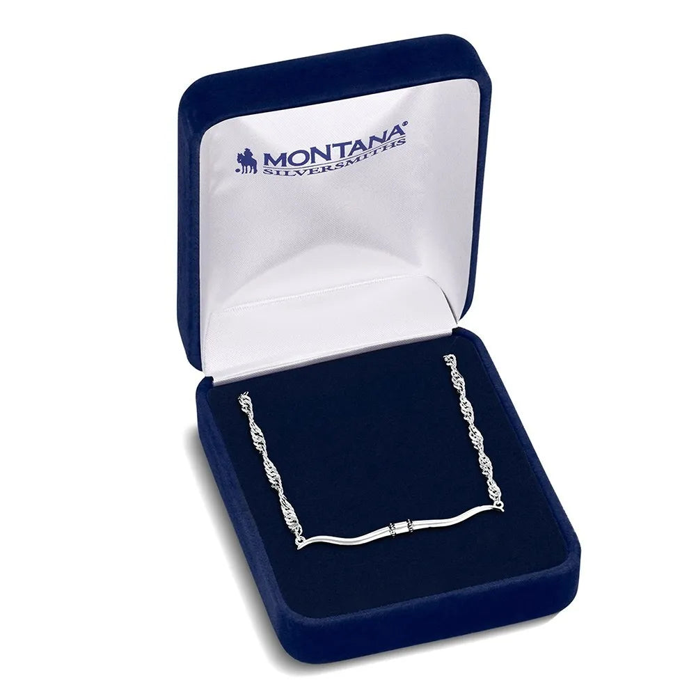 Silver bracelet in a blue jewelry box with 'Montana Silversmiths' branding.