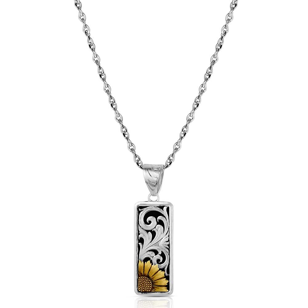 A silver rectangular pendant necklace featuring a black and silver scrollwork design with a yellow sunflower accent at the bottom, suspended on a silver chain against a white background.