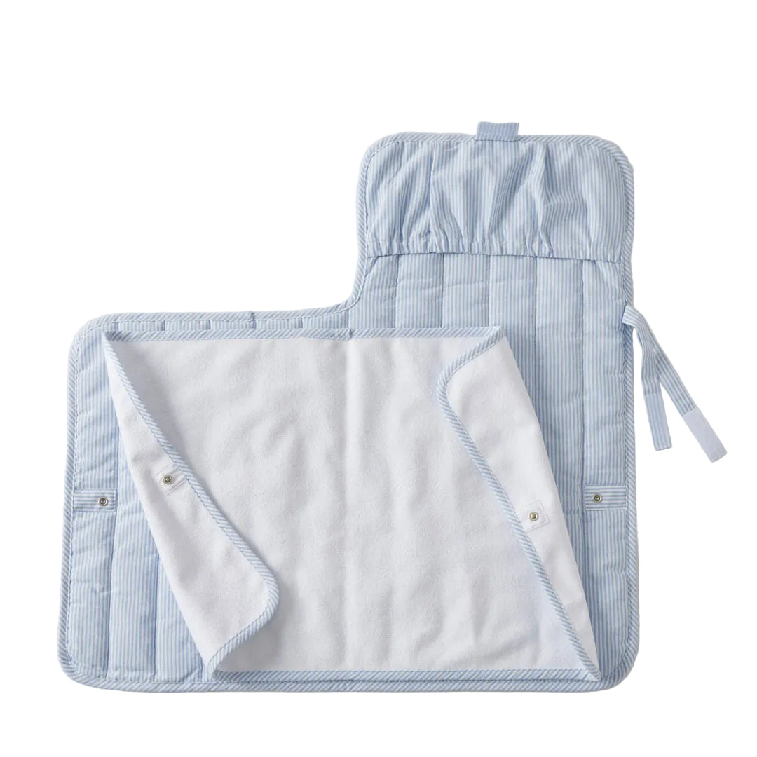 Blue and white striped baby changing pad on a light gray background