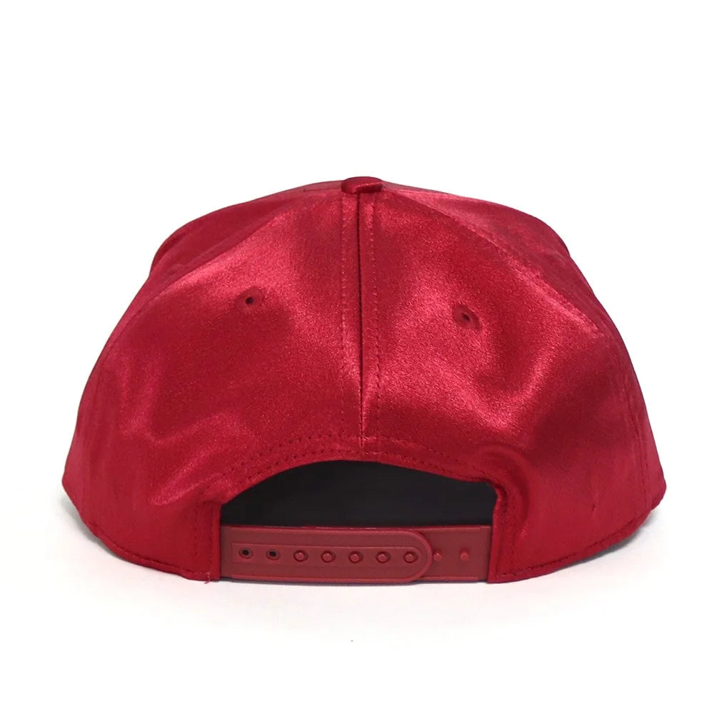 Red satin cap on a white background