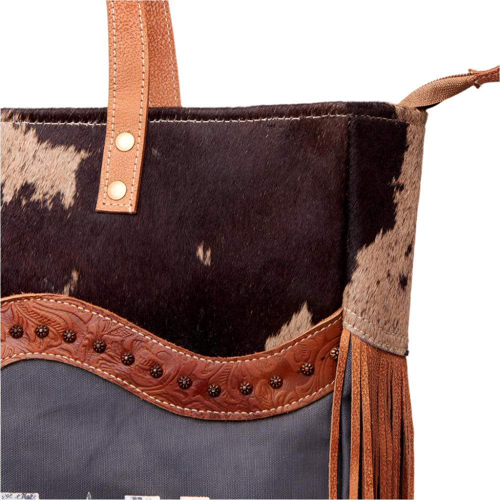 American Darling canvas and leather weekend bag with a 'CHATEAU' print on the front, brown straps, and a floral embossed leather detail.