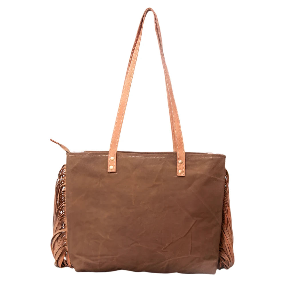 A brown and beige women's handbag with leather fringes and a 'Vintage' print on the front, featuring a star and the text 'American Darling'.