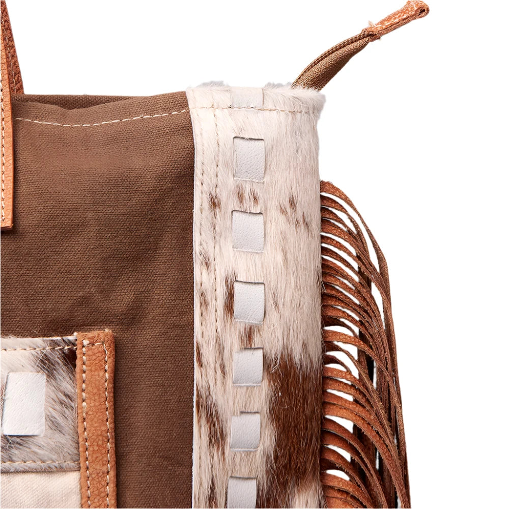 A brown and beige women's handbag with leather fringes and a 'Vintage' print on the front, featuring a star and the text 'American Darling'.