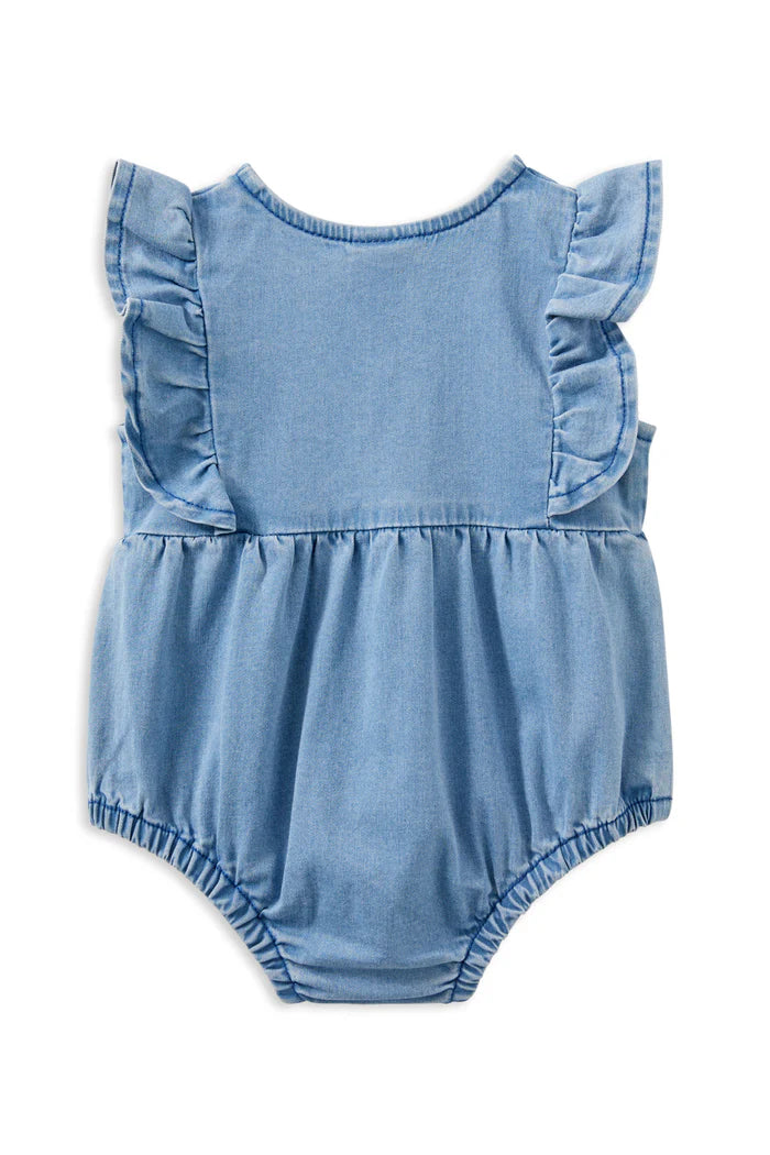 Milky Denim Frill Playsuit. Blue denim baby romper with ruffled sleeves on a white background