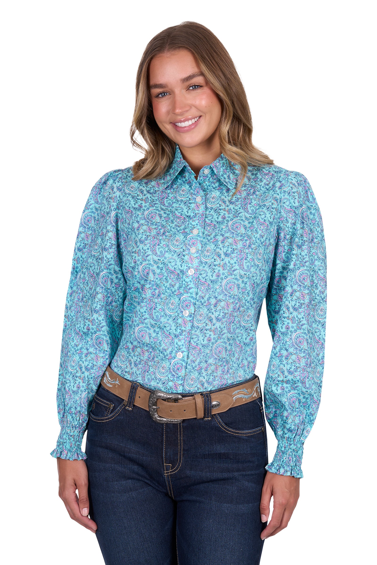 Pure Western Women's Riley L/S Western Shirt. Woman wearing a blue patterned shirt and dark jeans on a white background