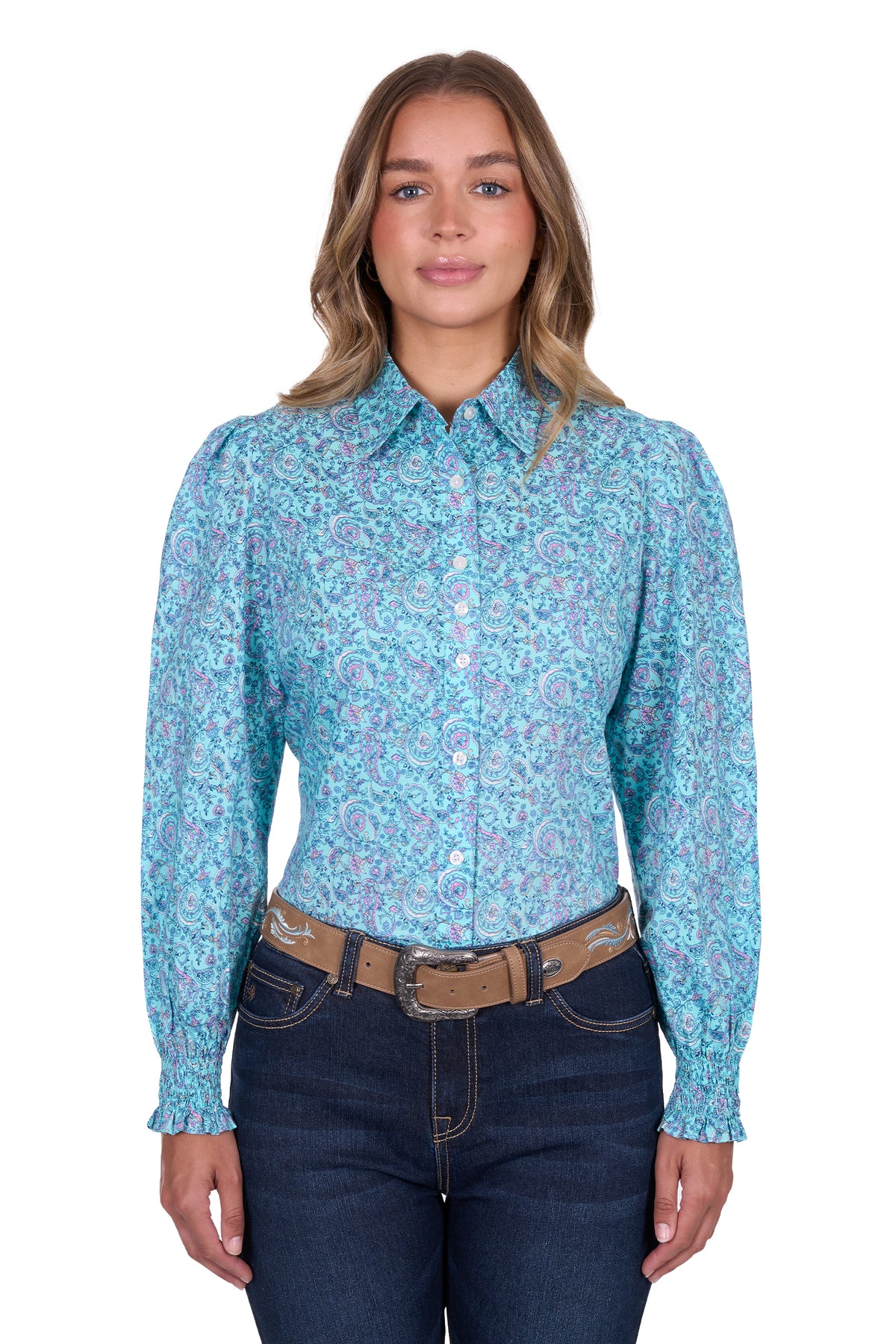 Pure Western Women's Riley L/S Western Shirt. Woman wearing a blue patterned shirt and dark jeans on a white background