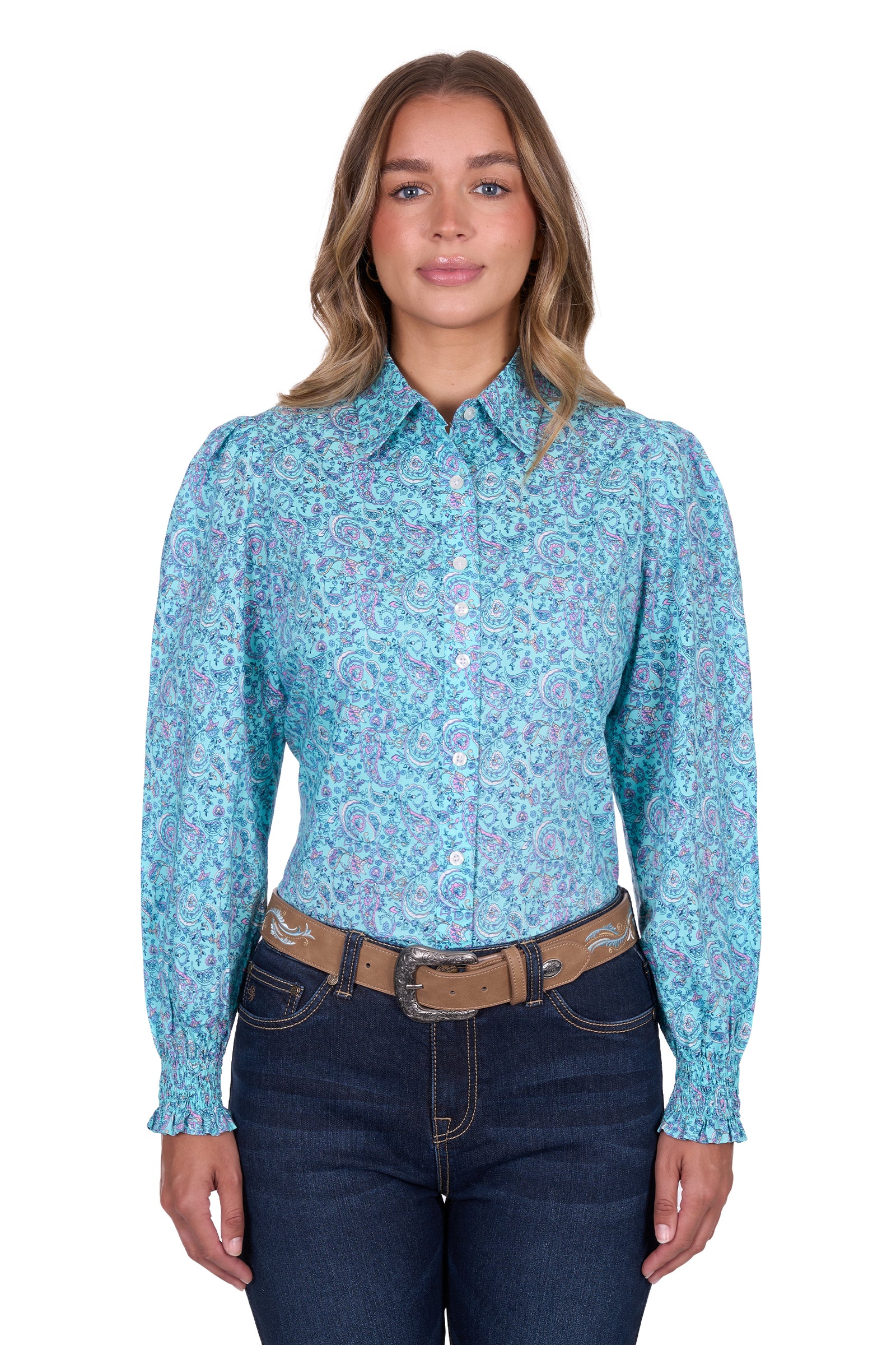 Pure Western Women's Riley L/S Western Shirt. Woman wearing a blue patterned shirt and dark jeans on a white background