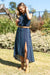 Pure Western Women's Agatha SkirtWoman in a blue patterned dress standing outdoors with greenery in the background 