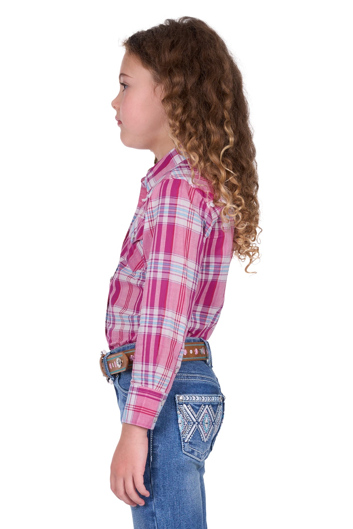Pure Western Girl's Leni L/S Western Shirt. Child wearing a pink plaid shirt and blue jeans on a white background
