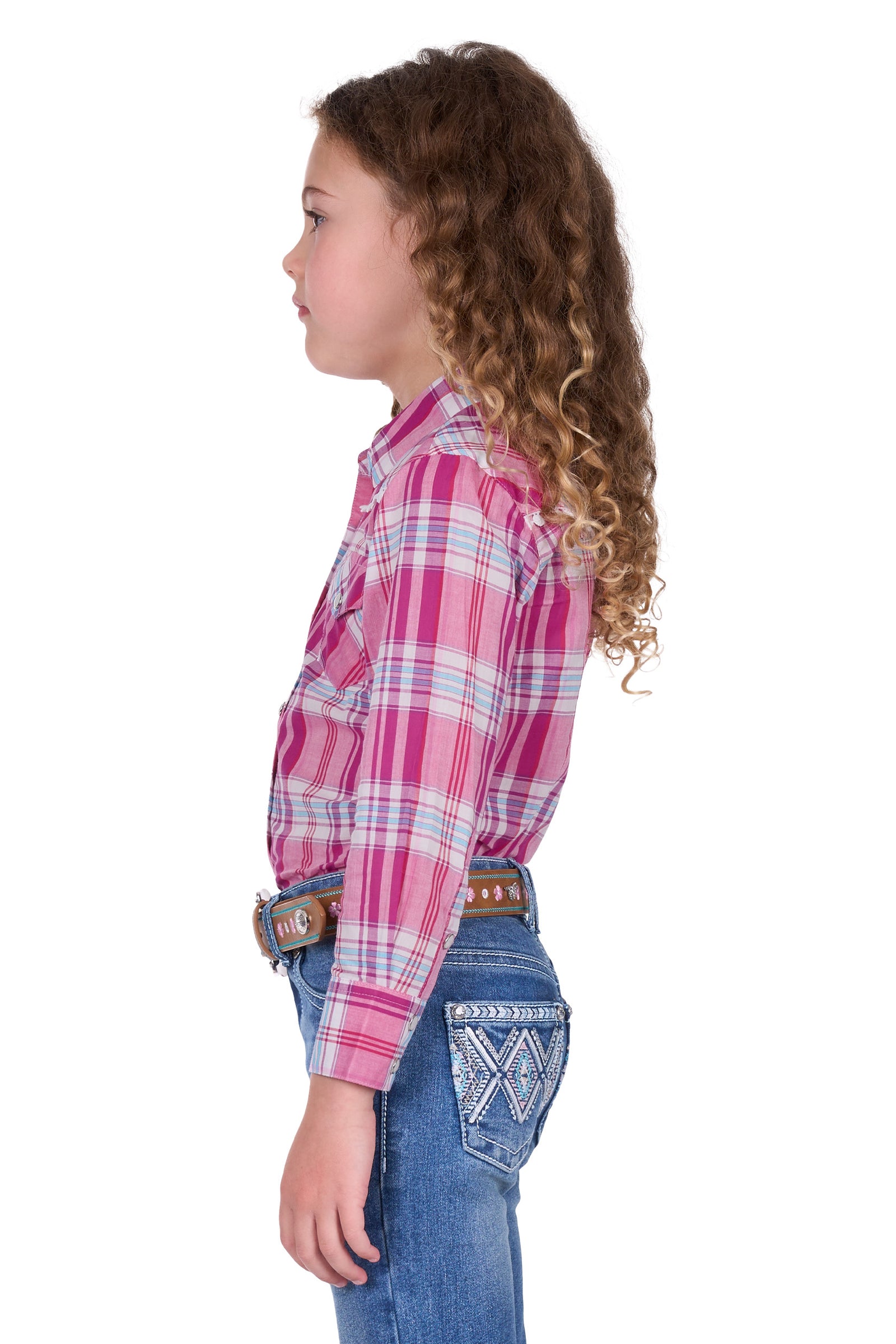 Pure Western Girl's Leni L/S Western Shirt. Child wearing a pink plaid shirt and blue jeans on a white background