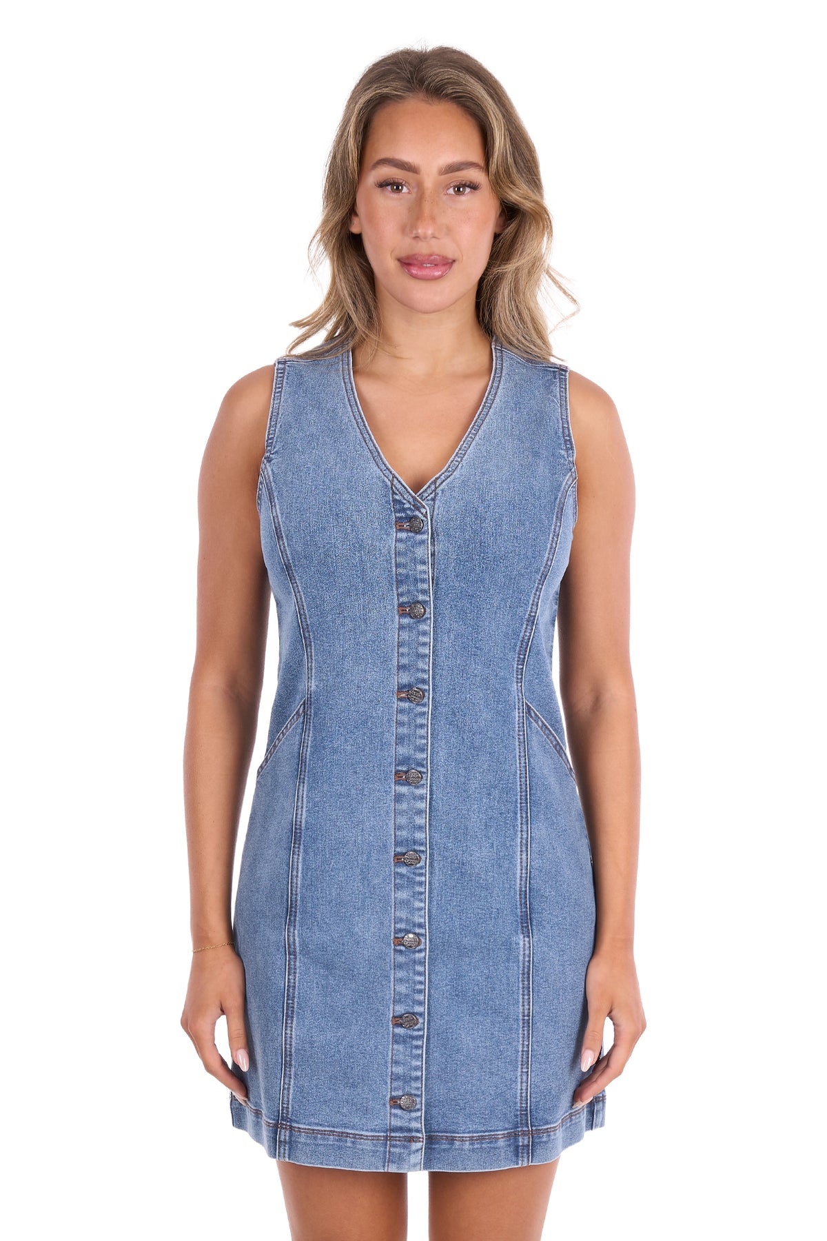 A woman modeling a sleeveless light blue denim mini dress with a button-down front, photographed against a plain white background.