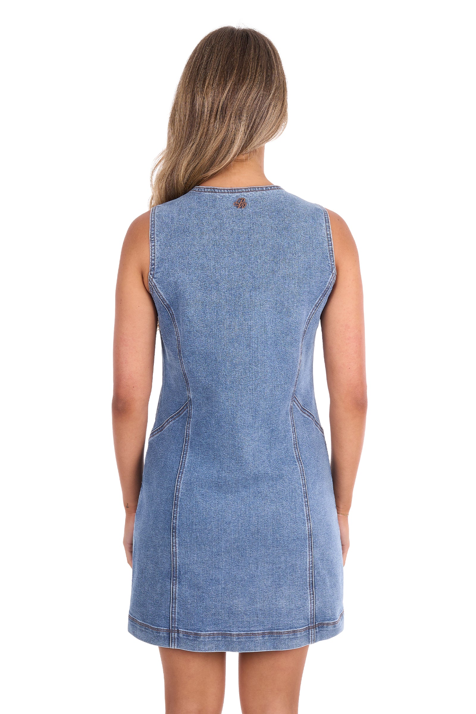 A woman viewed from the back wearing a sleeveless light blue denim dress against a plain white background.