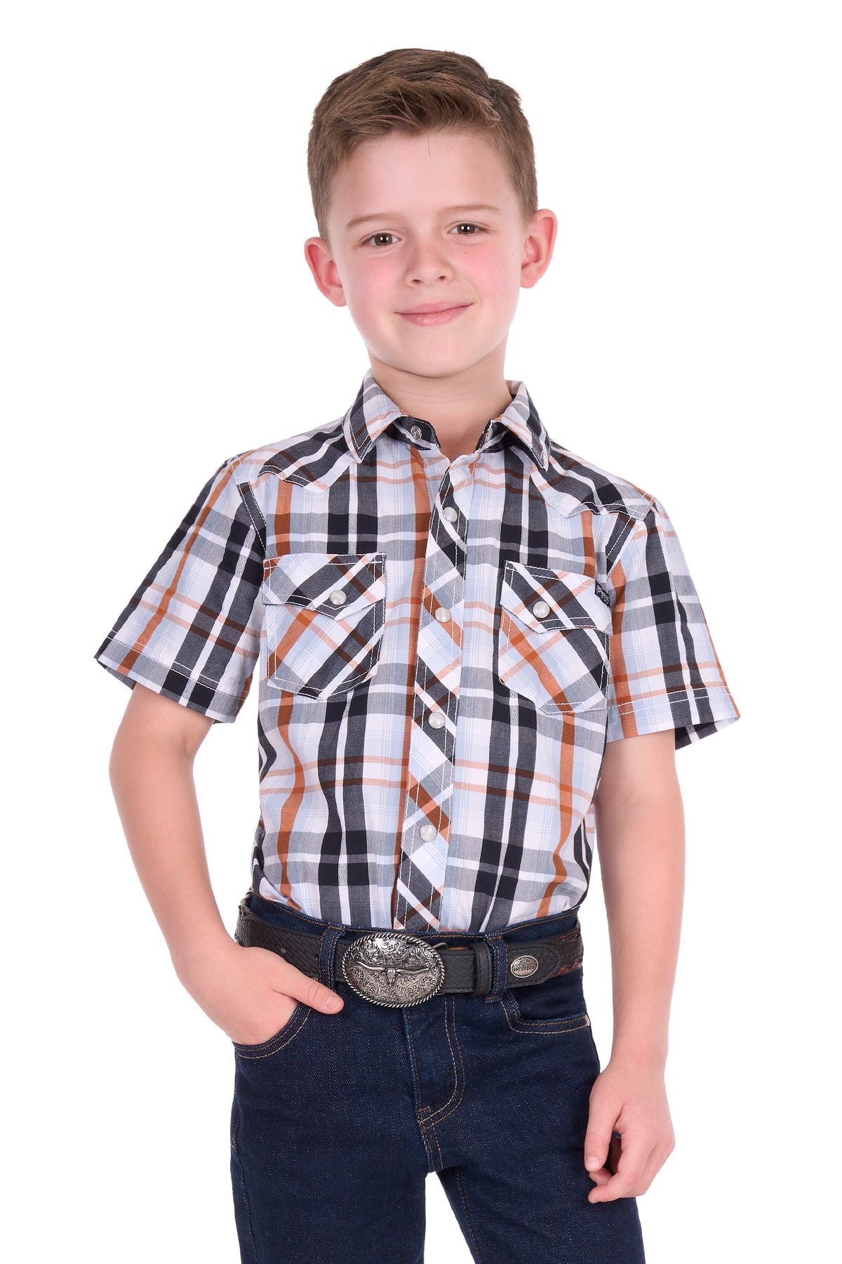 A young boy modeling a short-sleeve plaid button-down shirt with dark blue jeans and a western belt, shot against a solid white background.
