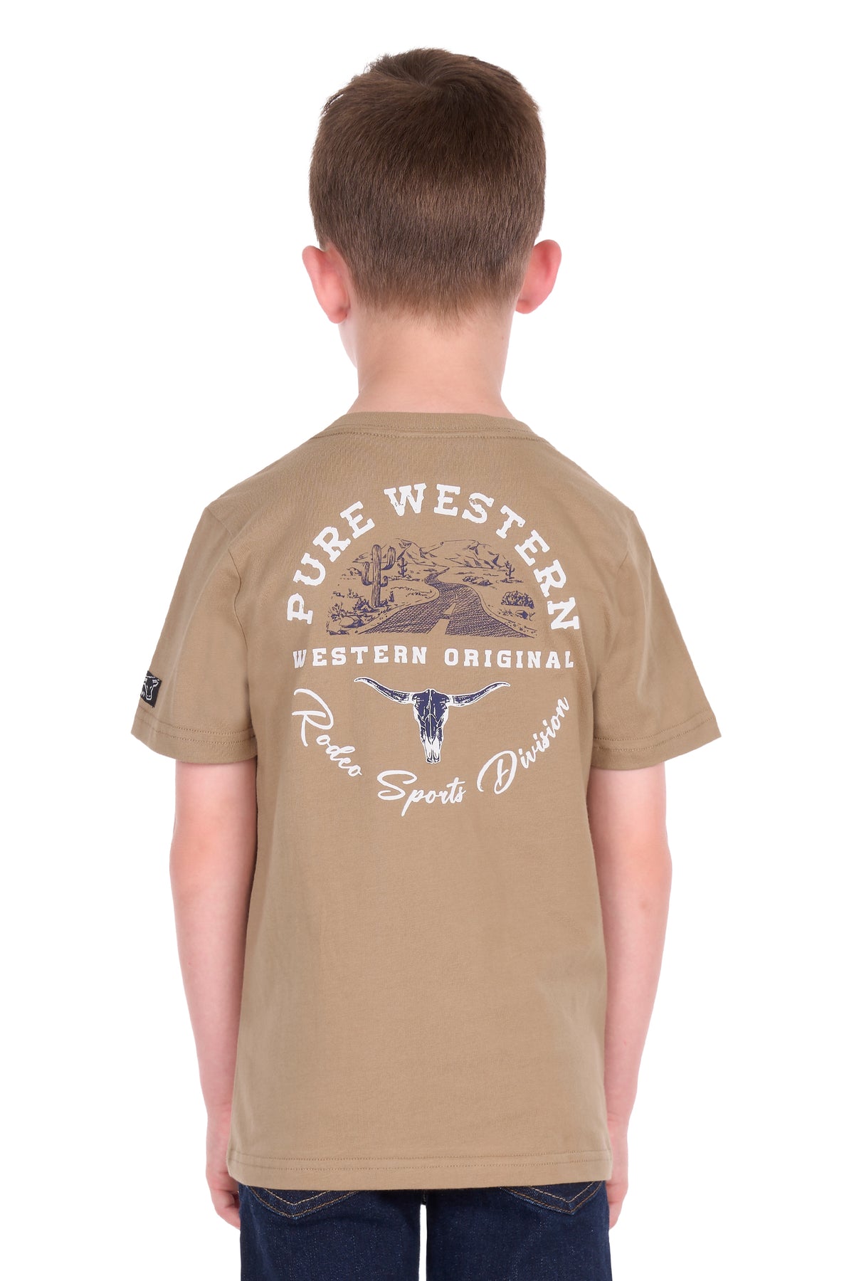 A child viewed from the back wearing a tan short-sleeve t-shirt with a large white and blue graphic print on the back that reads 'PURE WESTERN WESTERN ORIGINAL Roots Sports Division'.
