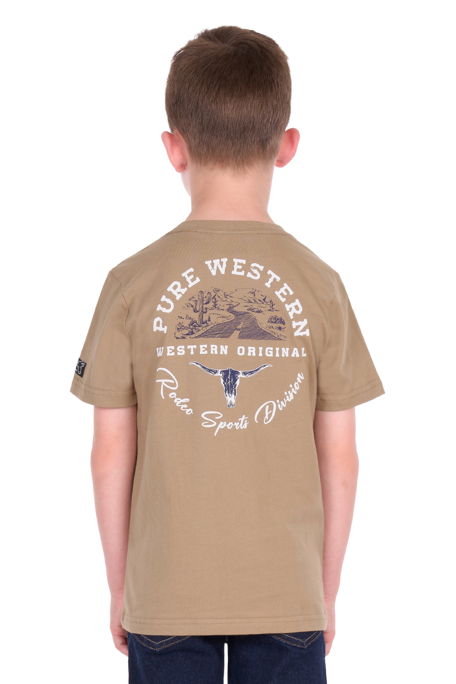 A child viewed from the back wearing a tan short-sleeve t-shirt with a large white and blue graphic print on the back that reads 'PURE WESTERN WESTERN ORIGINAL Roots Sports Division'.