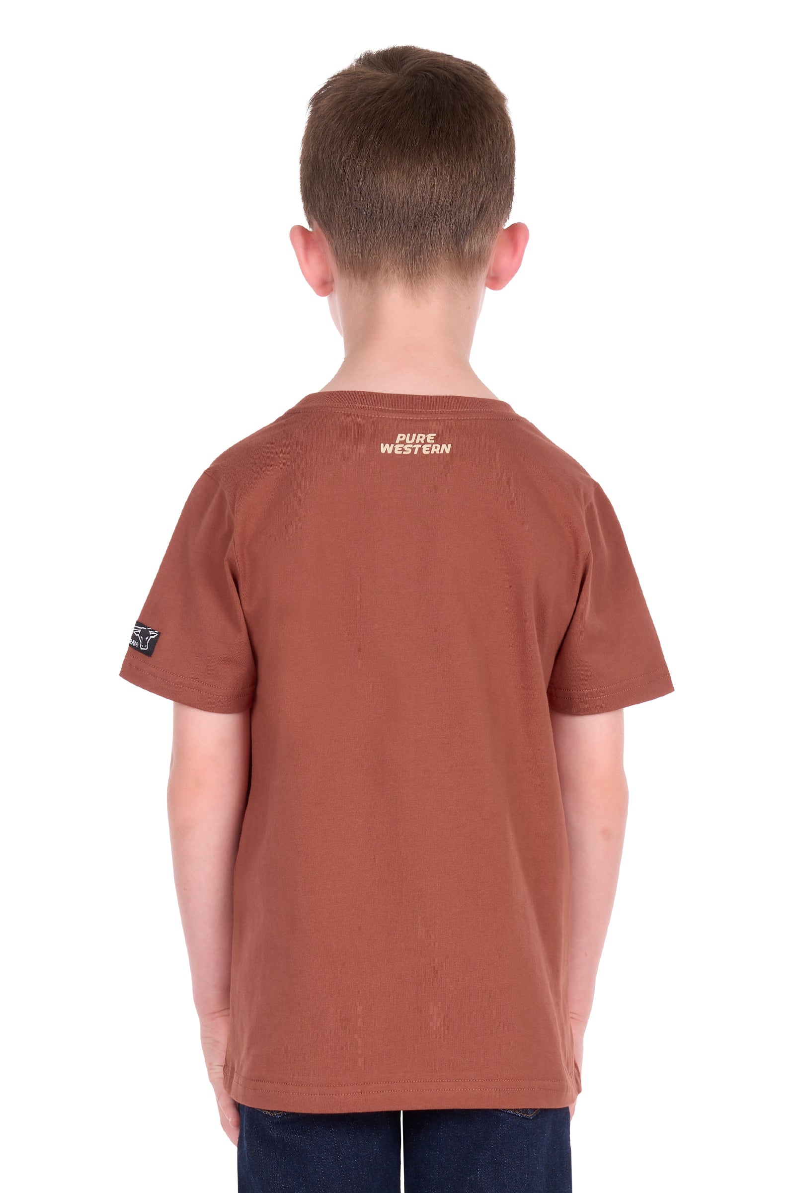 A child viewed from the back wearing a rust-brown short-sleeve t-shirt with 'PURE WESTERN' printed in white on the upper back and a small black logo patch on the left sleeve, set against a plain white background.