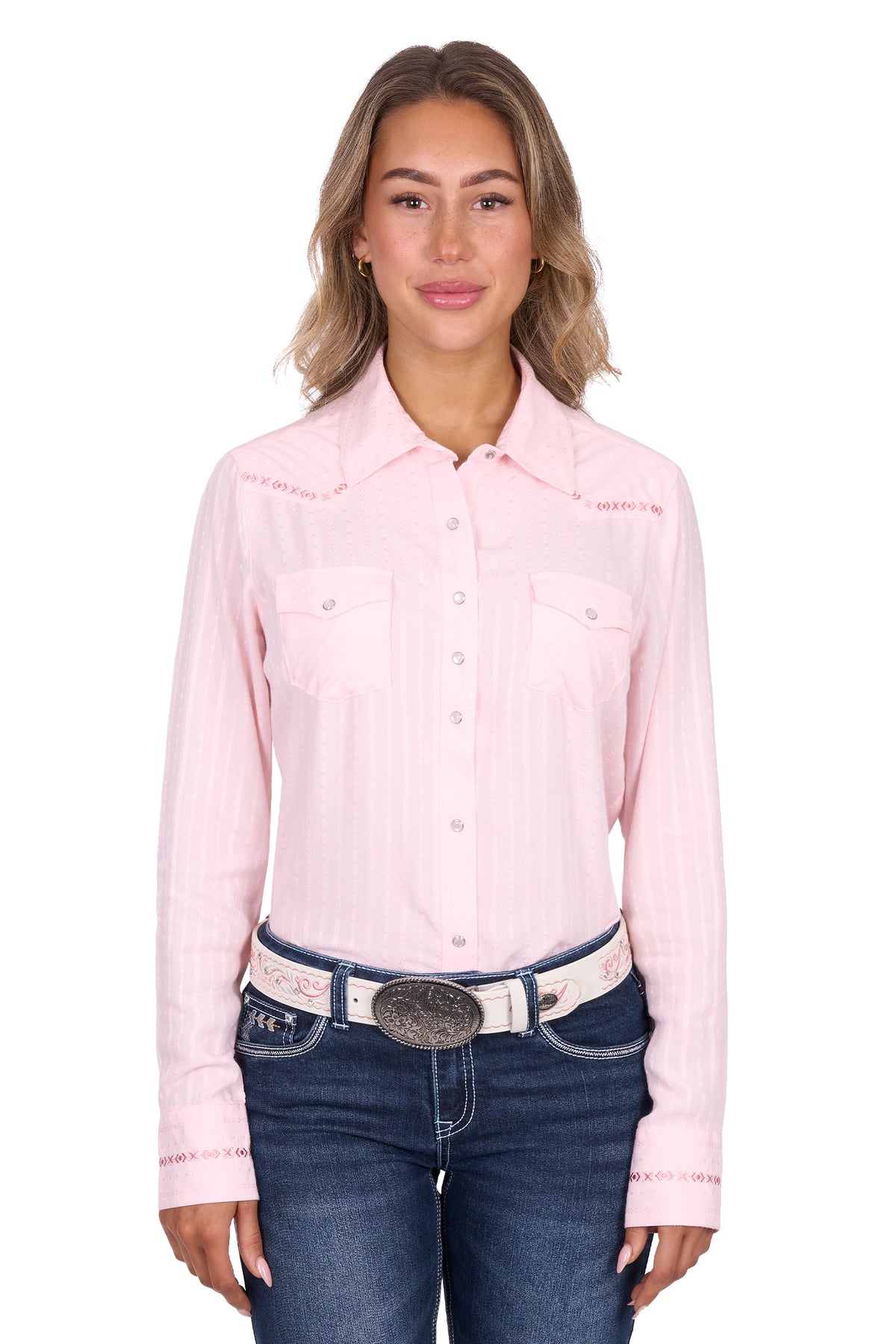 Woman wearing a pink long-sleeve shirt and blue jeans on a white background