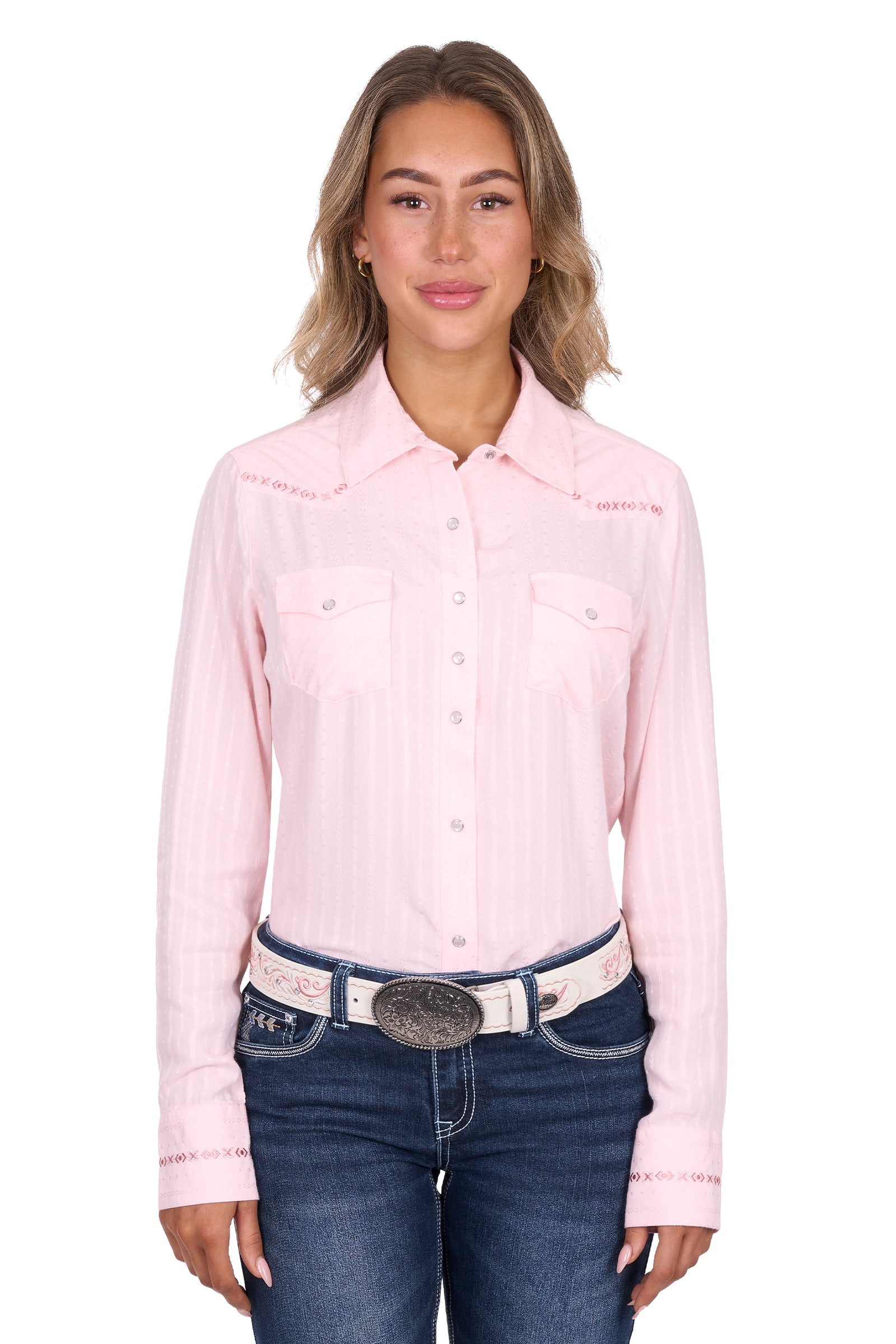 Woman wearing a pink long-sleeve shirt and blue jeans on a white background